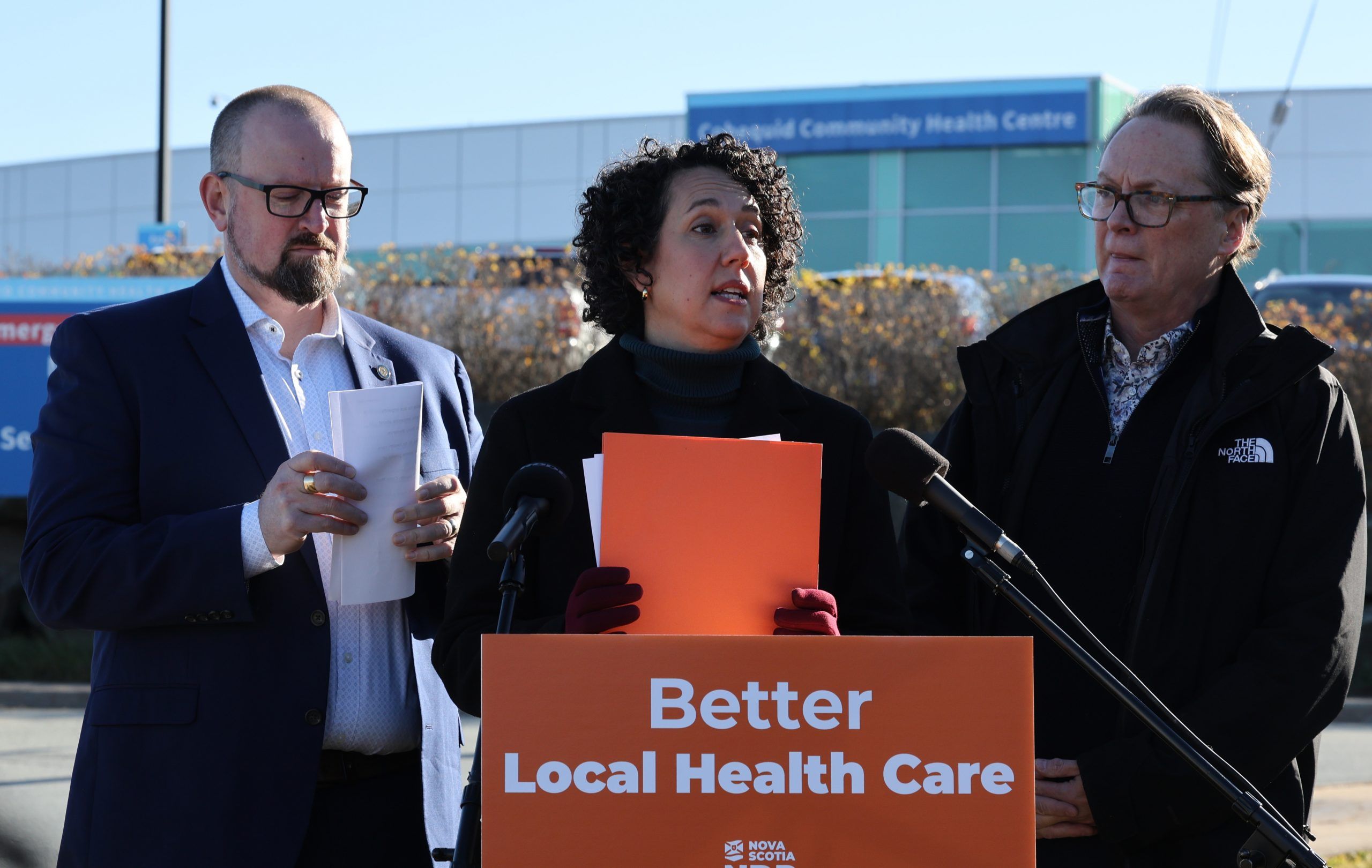 ndp members paul wozney, sackville-cobequid, and dr. rod wilson, halifax armdale, flank ndp leader claudia chender, during a news conference outside of cobequid community health centre in lower sackville on wednesday.