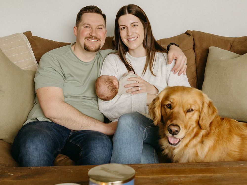 Shaugn, left, and Emily Best pose for a family photo with 11-month-old son James and Golden Retriever Sadie at their Kingston, P.E.I. home.