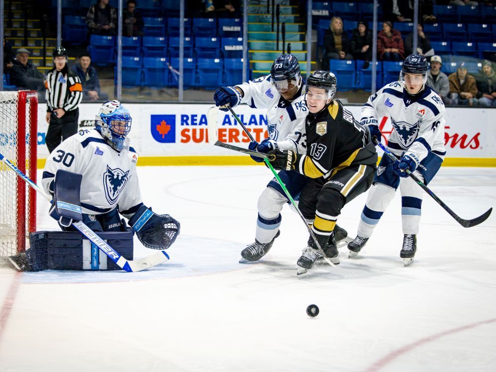 Charlottetown Islanders forward Matt Butler, 13, pursues a loose puck as Sherbrooke Phoenix defenceman PJ Fagan, 73, defends in a QMJHL game in Charlottetown on Jan. 22. Also following the play closely are Phoenix goaltender Kyan Labbe, 30, and forward Ilya Kolmakov, 19. Sherbrooke won the game 5-2.