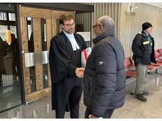 Crown attorney Sean McCarroll shakes hands with a member of the Halifax Somali community who attended Nova Scotia Supreme Court on Wednesday for Hassan Abdi Jama's sentencing on a charge of assault causing bodily harm. Jama, a Somali refugee who has permanent resident status in Canada, received a sentence of six months less a day, deemed time served on remand.