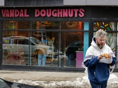 Aaron MacLeod prepares to eat a jam buster from Vandal Doughnuts on Gottingen St. in Halifax on Friday. MacLeod said he was a regular customer and that it was unfortunate the shop will be closing on Sunday.