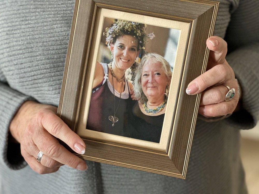 Diane Axent holds a framed photo of her and her daughter Erica Joy Axent Hilton following her daughter's Feb. 11 death. The photo depicts a time when Erica helped her mom at a Ukrainian event. The mother and daughter were both proud of their roots. Erica had made her headpiece from flowers she had gathered during an event in Halifax to celebrate Ukrainians. CONTRIBUTED
