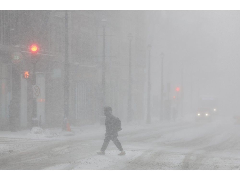 Near whiteout conditions slowed traffic on Barrington Street in Halifax on Monday. As a result of a winter storm, delivery of The Chronicle Herald will be delayed on Tuesday. Some newspapers may arrive with Wednesday's edition.