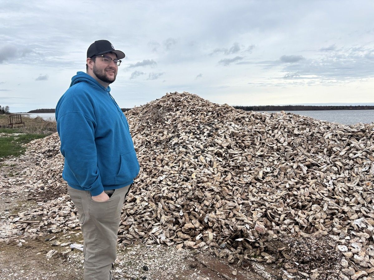 Thomas Burleigh, leader of the P.E.I. NDP, stands next to a pile of oyster shells in behind his business, Burleigh Bros. Seafood. Kristin Gardiner
