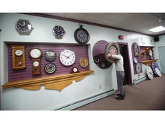 Sam Francis, a horologist at Doctor Clock, changes the time on a clock at the store in Halifax on March 10, 2023.