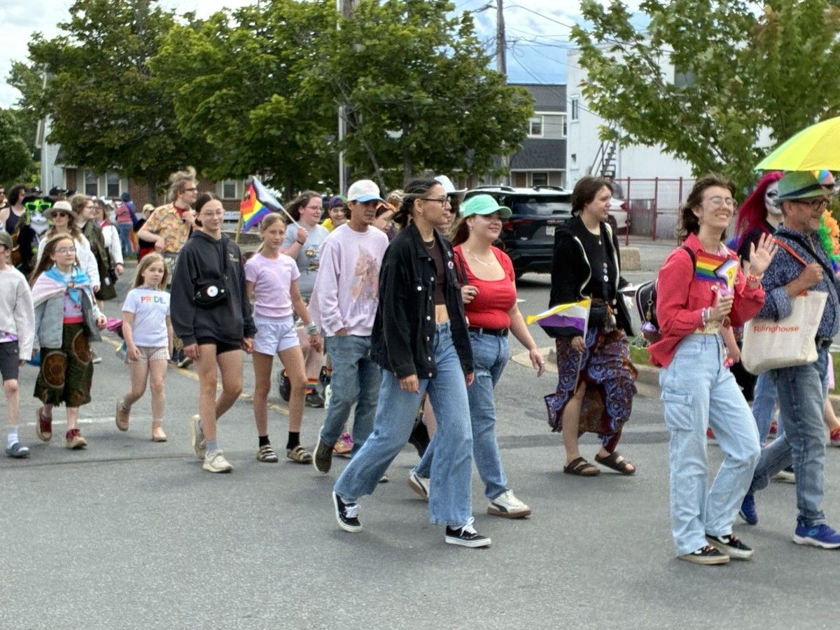  a participant waves as a few hundred people walk through kentville in valley pride’s annual pride month march saturday.