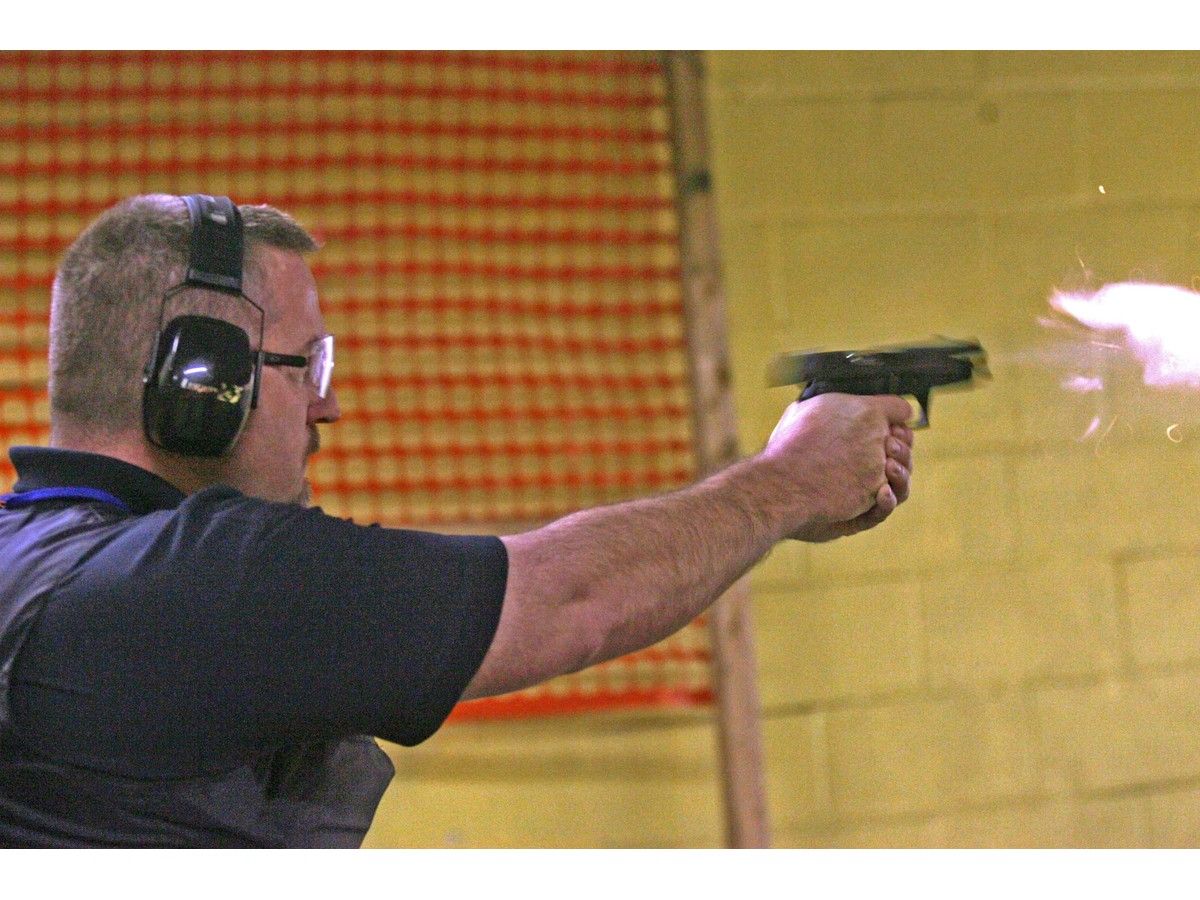 Bermudan police officer turned Halifax police constable-in-training, Robin Sherwood, fires at a target during pistol training with fellow lateral police cadets at a Dartmouth firing range, Thursday March 29, 2007.