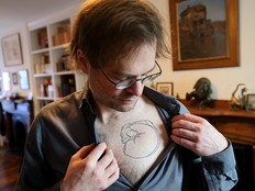 Vincent Masse displays the tattoo of his late dog, Balthazar, in his Halifax home on Tuesday. A specialized tattoo artist in Winnipeg used ink that included some of Balthazar's ashes, but only after Masse faced several hurdles trying to get the cremated remains and the box that contained them through airport security.