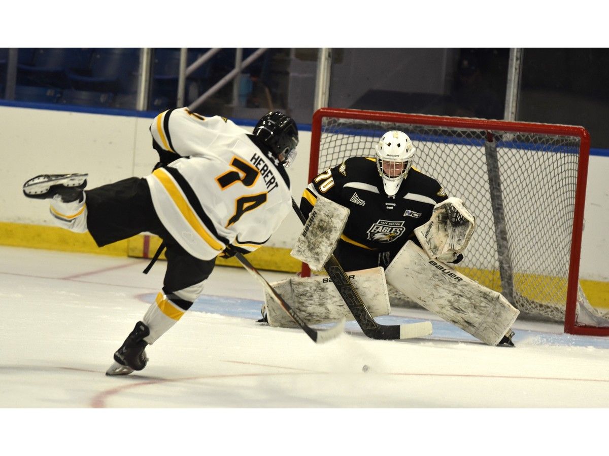 Jérémie Hébert, left, fires a shot on goal on Alexis Noel during intrasquad action at Cape Breton Eagles rookie camp at Centre 200 in Sydney on Thursday. JEREMY FRASER/CAPE BRETON POST