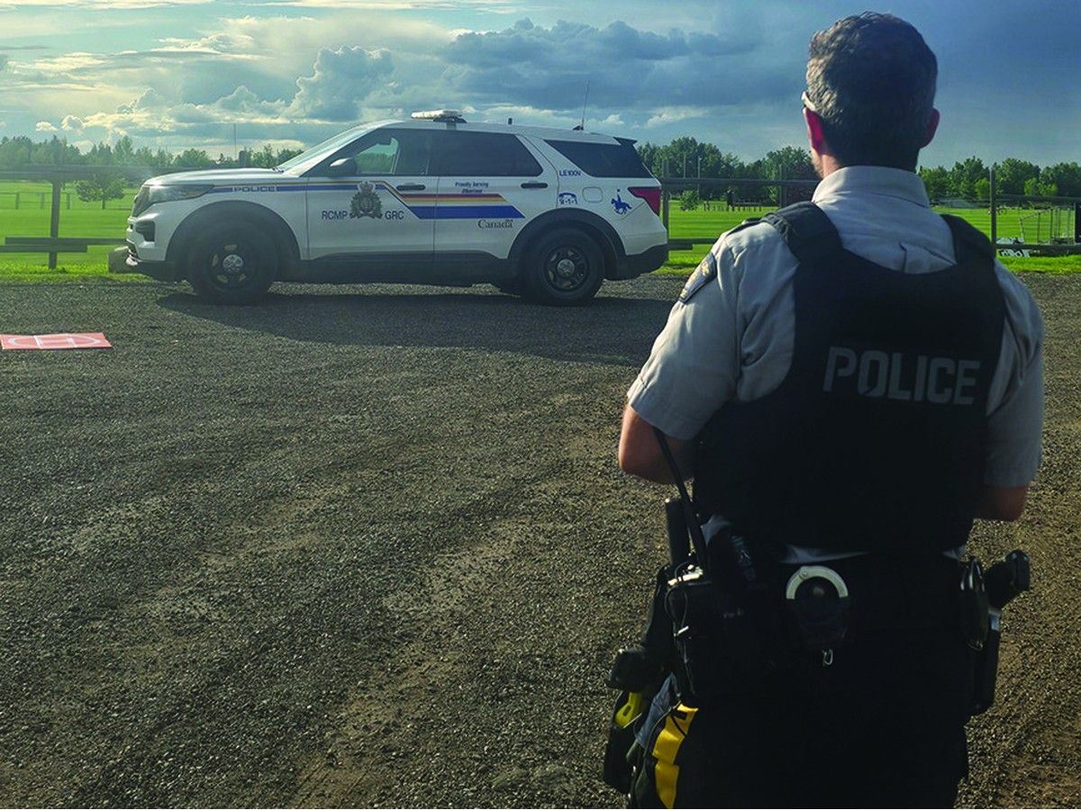 An RCMP officer near his police cruiser.