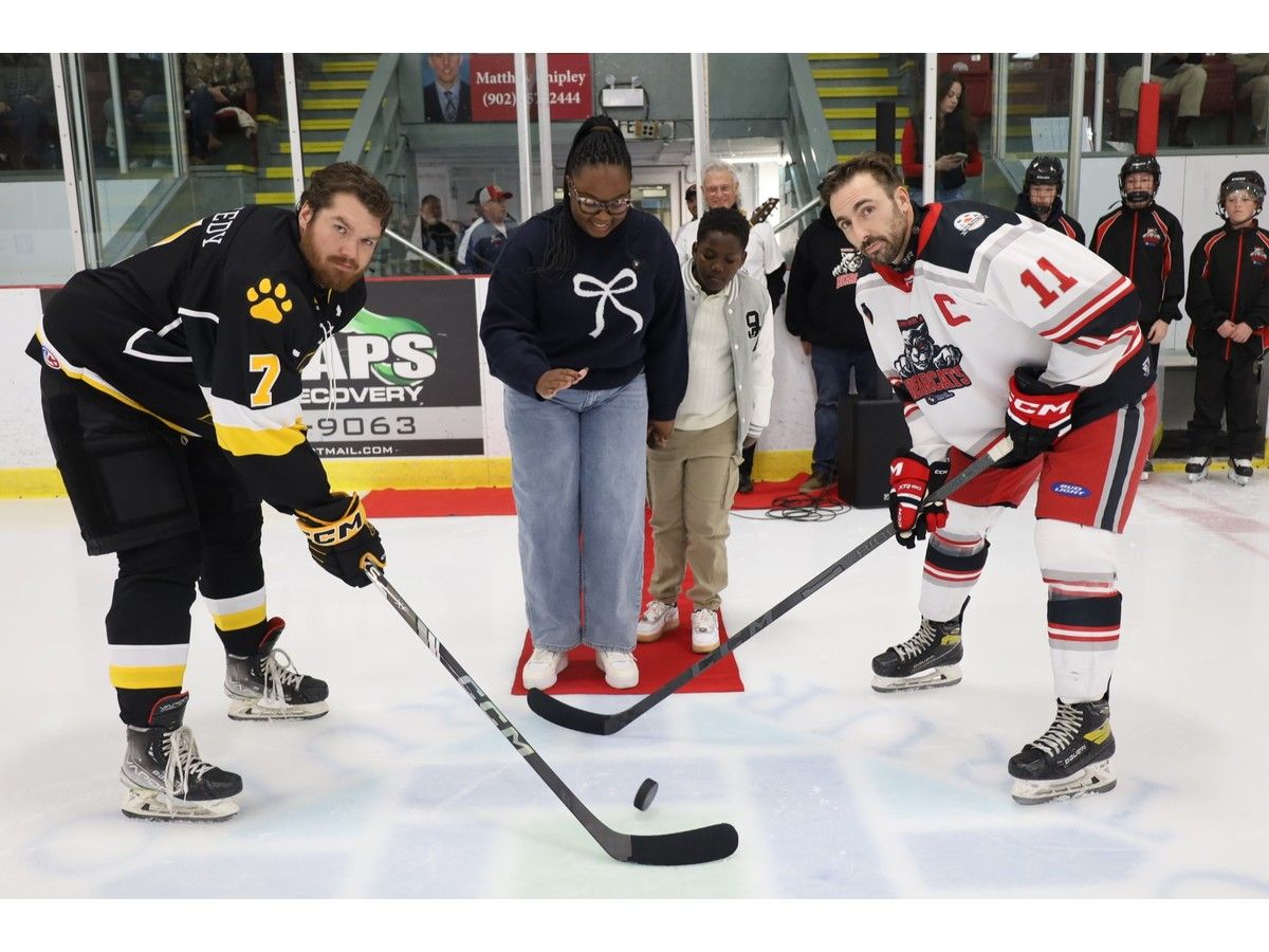 Shanice Green, branch manager at Mosaik Credit Union, and her son, Leondre, took part in the ceremonial puck drop before the game on Oct. 10 at the Colchester Legion Stadium. The Mosaik Credit Union is the Truro team's title sponsor. Antigonish Bulldogs captain Brad Kennedy, left, and Truro Mosaik Bearcats captain Colin Campbell also participated.