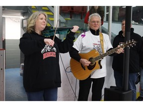 Local musicians Julie Johnstone, left, and Bob Prest perform the national anthem at the Truro Mosaik Bearcats home opener on Oct. 10.