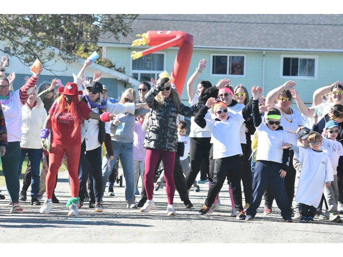 Participants of the Sou'West Colour Walk fundraiser put on by the Yarmouth Hospital Foundation do some warmup activities before heading out on their walk on Oct. 18. TINA COMEAU