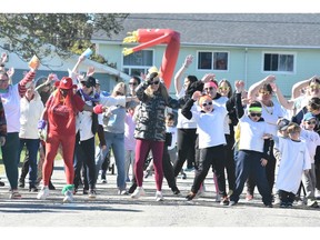 Participants of the Sou'West Colour Walk fundraiser put on by the Yarmouth Hospital Foundation do some warmup activities before heading out on their walk on Oct. 18. TINA COMEAU