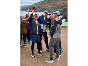 Smiles, cheers and thumbs up during a photo taken in Meat Cove, Cape Breton, to celebrate the end of Landon Smith's 804-kilometre, tip-to-tip run across Nova Scotia in support of Autism Nova Scotia. CONTRIBUTED