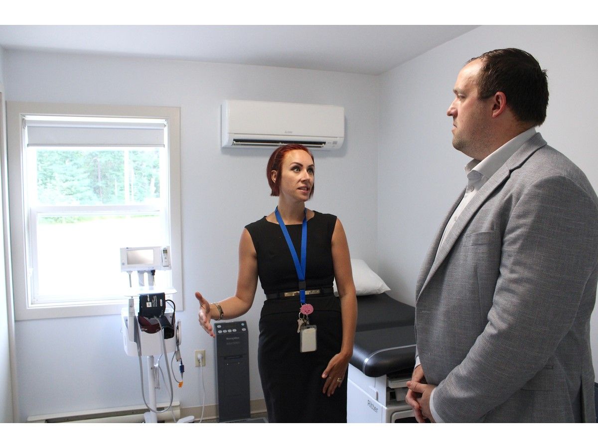 Alex Marcia, left, manager of the mental health and addictions day hospital in Kentville, gives Brian Comer, Nova Scotia's minister of Addictions and Mental Health a tour of the facility on July 24.