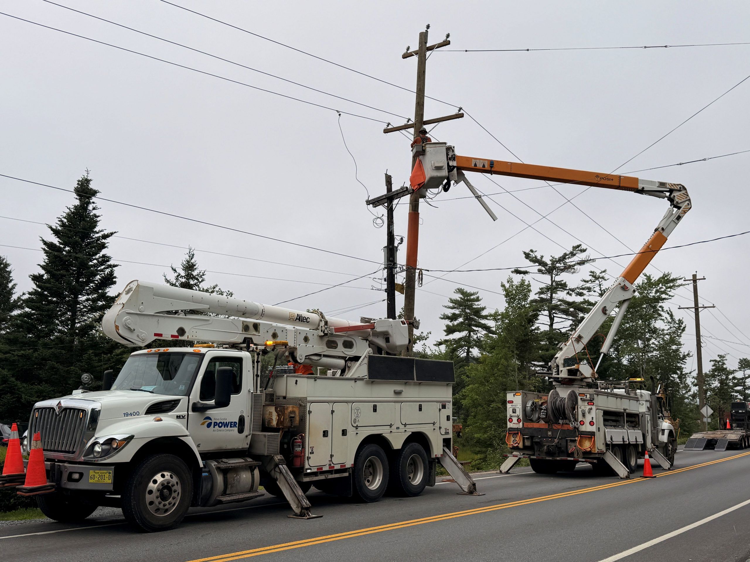 Nova Scotia Power employees works on a power line on Peggys Cove Road.