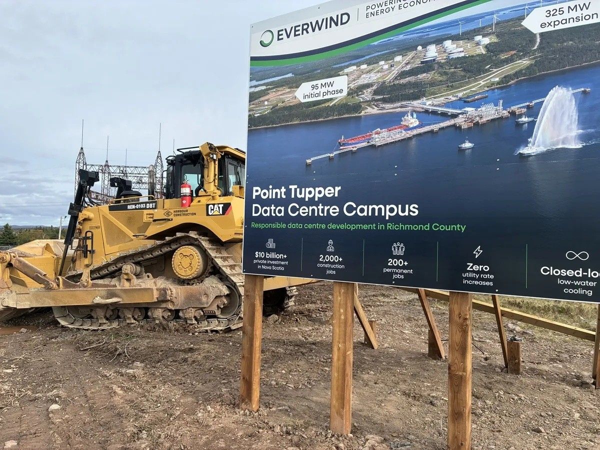 Construction equipment sits next to a sign at the future site of EverWind's green hydrogen plant and data centre in Point Tupper, N.S.
