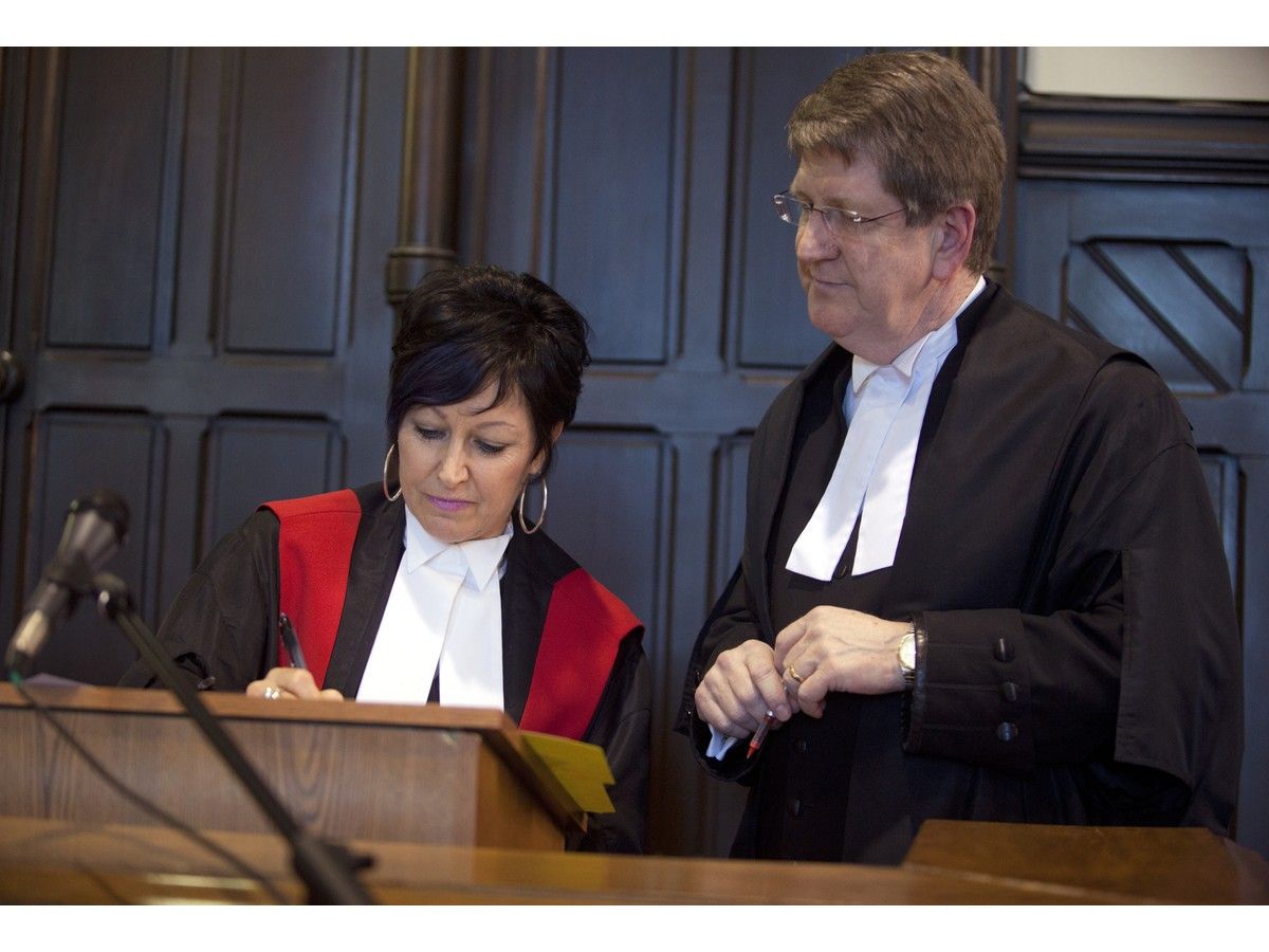 Pamela Williams signs documents at her swearing-in as chief judge of the Nova Scotia provincial court in May 2013 under the watchful eye of Michael MacDonald, who was the province's chief justice at the time. Williams, who's now a part-time judge, has reserved her decision until Oct. 29 at a Hammonds Plains man's bail hearing on charges of abusing his intimate partner on three occasions. - FILE PHOTO