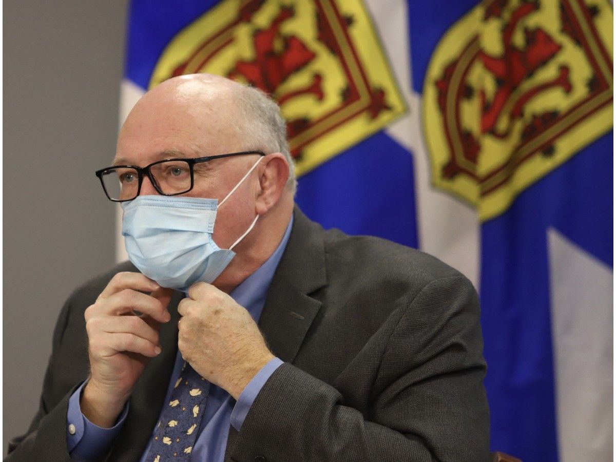 Dr Robert Strang puts on his mask following a news conference in Halifax on Friday December 16, 2022.