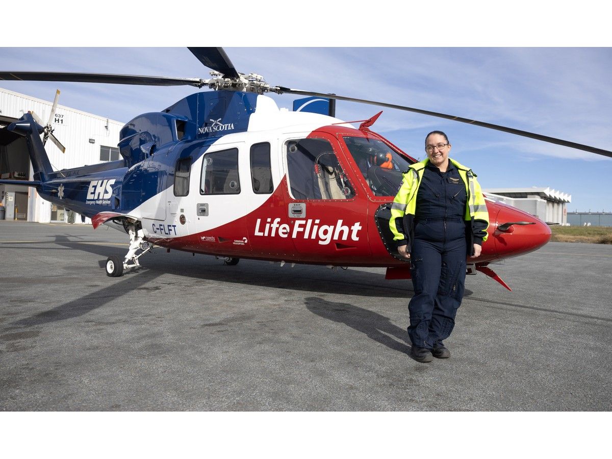 Jessica Carew, a registered respiratory therapist, poses for a photo next to an EHS LifeFlight helicopter at the Halifax Stanfield Airport on Monday, Oct. 19, 2026.