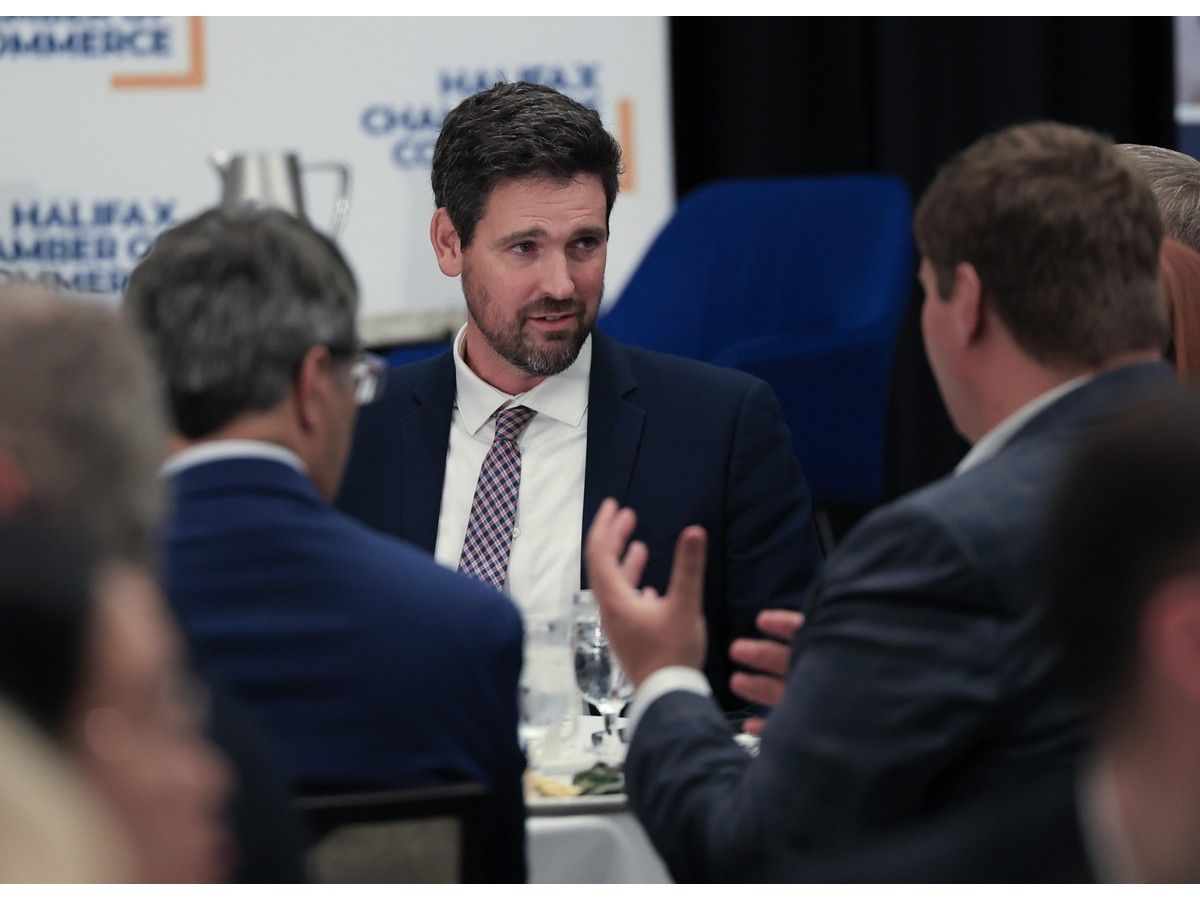 Sean Fraser, the minister responsible for the Atlantic Canada Opportunities Agency, speaks with members of his table before addressing a gathering for the Halifax Chamber of Commerce in Halifax on Wednesday.