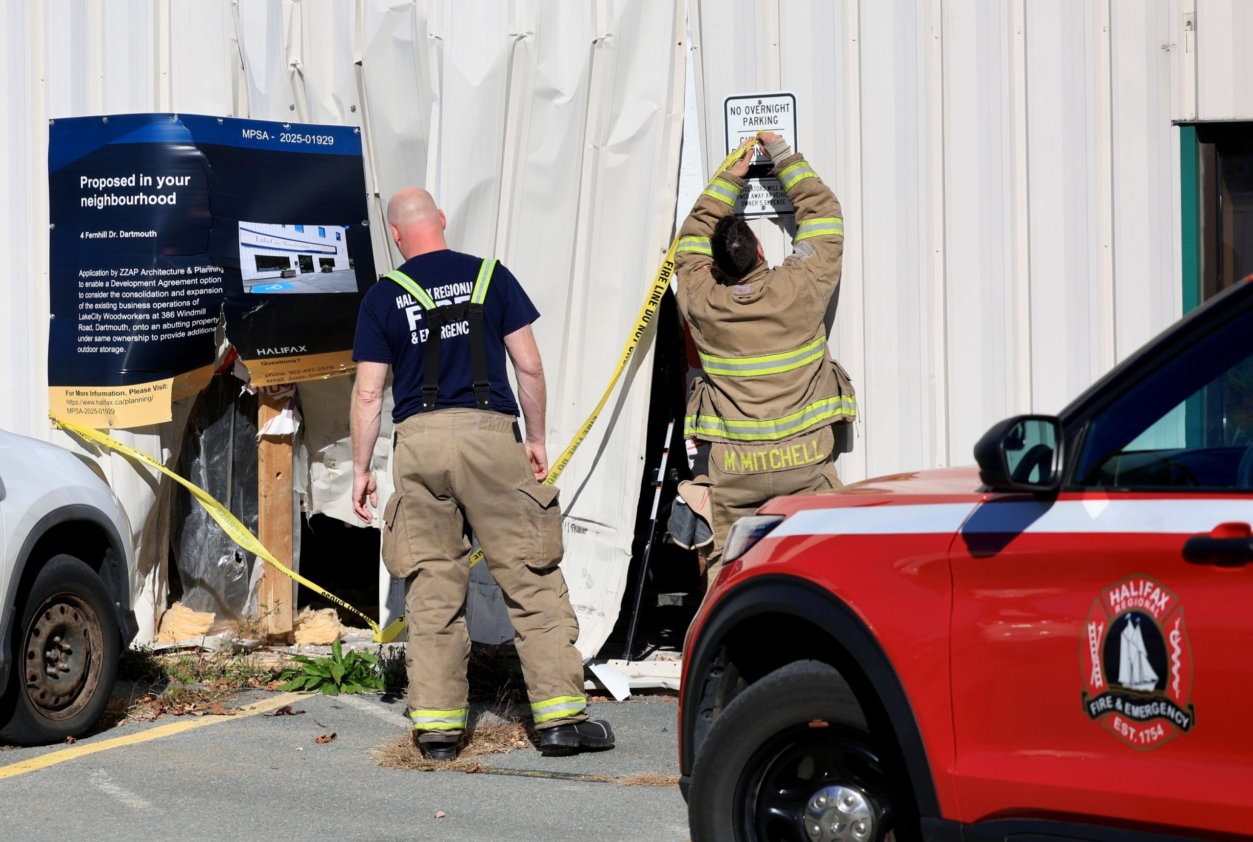 Firefighters put caution tape over the area where a vehicle had driven into Lake Ciry Woodworkers in Dartmouth on Tuesday.