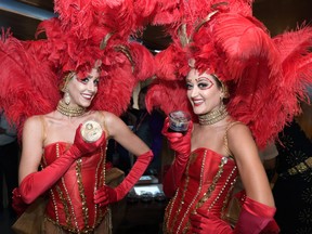 Showgirls hold cannabis flowers during the grand opening of MedMen in Las Vegas in 2018.