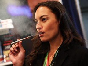 FILE - Jordan Michelle vapes a CBD oil made from hemp at the Cannabis World Congress Conference on June 16, 2017 in New York City.