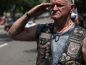 FILE: A U.S. veteran salutes as thousands of bikers and military veterans take part in the Rolling Thunder motorcycle parade in Washington DC, on May 27, 2018. /
