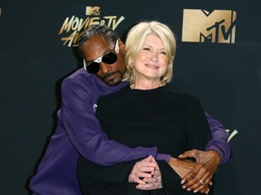 FILE: Snoop Dogg (L) and Martha Stewart pose in the press room during the 2017 MTV Movie & TV Awards at the Shrine Auditorium, in Los Angeles, Calif. on May 7, 2017. /