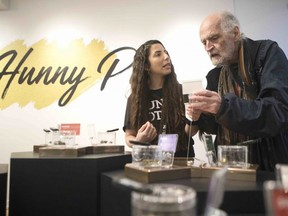 FILE: Jean-Pierre Fortin (right) shops for cannabis on the first morning of opening at Toronto's "The Hunny Pot," one of the retail stores licensed to sell cannabis in Ontario, on Monday, April 1, 2019.