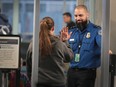 FILE: A Transportation Security Administration (TSA) worker screens passengers and airport employees at O'Hare International Airport on Jan. 07, 2019 in Chicago, Ill. /