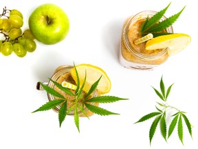 Fruit smoothies with marijuana on white background