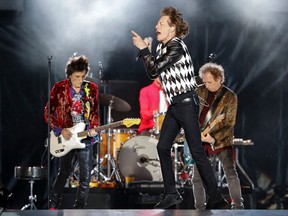 FILE: Ronnie Wood (L), Mick Jagger (C), Charlie Watts (partially hidden) and Keith Richards of the Rolling Stones perform as they resume their "No Filter Tour" North American Tour at the Soldier Field on June 21, 2019 in Chicago. /