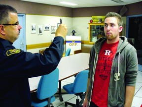 FILE: Ontario Provincial Police Const. John Rozich, left, demonstrates part of the drug recognition test with an OPP auxiliary officer in Ottawa. /