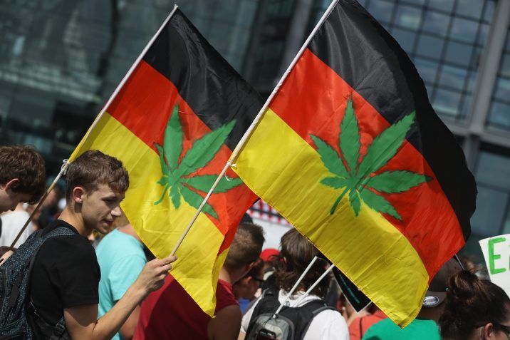 FILE: Activists, including two waving German flags that have a marijuana leaf painted on them, demanding the legalization of marijuana prepare to march in the annual Hemp Parade (Hanfparade) on Aug. 13, 2016 in Berlin, Germany. /