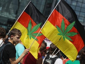 FILE: Activists, including two waving German flags that have a marijuana leaf painted on them, demanding the legalization of marijuana prepare to march in the annual Hemp Parade (Hanfparade) on Aug. 13, 2016 in Berlin, Germany. /
