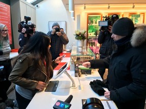 FILE: People gather as a customer buys CBD oil at the new Fire and Flower pot store on Apr. 1, 2019 in Ottawa, Ont. /