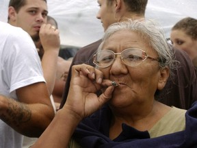 FILE: A woman smokes a marijuana joint at Hempfest on Aug. 21, 2004 in Seattle, Wash. /