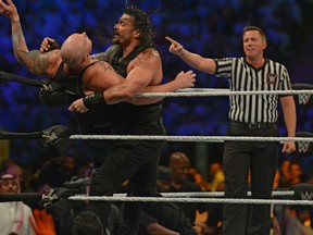 FILE: Roman Reigns (R) fights against Baron Corbin during the World Wrestling Entertainment (WWE) Crown Jewel pay-per-view in Riyadh on Oct. 31, 2019. /
