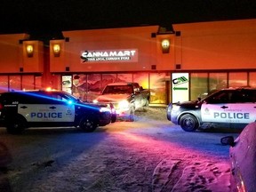 Police cars parked outside a cannabis store in Ontario