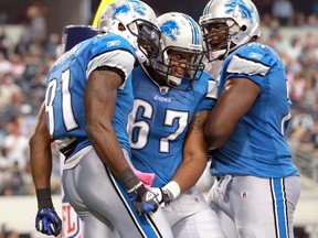 FILE: Calvin Johnson #81 of the Detroit Lions celebrates his touchdown in the endzone with teammates Rob Sims #67 and  Gosder Cherilus #77 during the second half against the Dallas Cowboys at Cowboys Stadium on October 2, 2011 in Arlington, Texas.