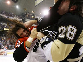 FILE: Riley Cote of the Philadelphia Flyers and Eric Godard  of the Pittsburgh Penguins fight during the first period at the Mellon Arena on December 15, 2009 in Pittsburgh, Pennsylvania. Photo by Bruce Bennett/Getty Images