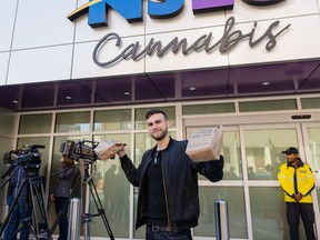 File - A Nova Scotian celebrates buying regulated cannabis on the first day of legalization, Oct. 17, 2018.