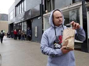 FILE: Mike, 29, with cannabis products purchased from J. Supply Co., Windsor's first cannabis retail store, on March 28, 2020.