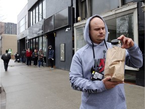 FILE: A customer departs J. Supply Co. in downtown Windsor on March 28, 2020, the opening day of Windsor's first legal retail pot shop. /