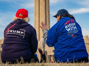 A President Donald Trump and a former Vice President Joe Biden supporter converse before the Joe Biden Campaign Rally at the National World War I Museum and Memorial on March 7, 2020 in Kansas City, Missouri.
