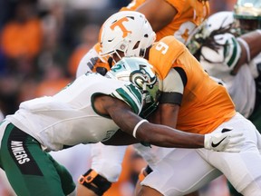 FILE: Running back Tim Jordan #9 of the Tennessee Volunteers runs for yards with Ed Rolle #2 of the Charlotte 49ers defending during the first quarter the game between the Charlotte 49ers and the Tennessee Volunteers at Neyland Stadium on Nov. 3, 2018 in Knoxville, Tenn.