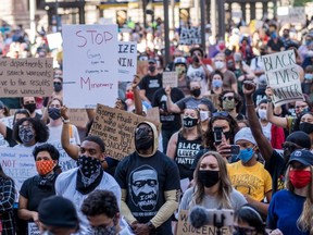 FILE: Protesters gather outside the Hennepin county Government Center during a Justice for George Floyd demonstration on June 11, 2020 in Minneapolis, Minn.